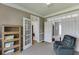 Functional office with French doors, a relaxing chair, storage and a neutral color scheme throughout at 1673 Chadwick Ridge Dr, Lawrenceville, GA 30043