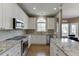 Eat-in kitchen with white cabinetry, stainless steel appliances, and granite countertops providing a modern and functional space at 1673 Chadwick Ridge Dr, Lawrenceville, GA 30043