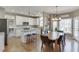 Spacious kitchen with white cabinets, stainless appliances, granite counters, and a seamless transition to the dining area at 1673 Chadwick Ridge Dr, Lawrenceville, GA 30043