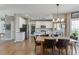 Open floor plan with a kitchen featuring stainless steel appliances, a granite island, and a dining area at 1673 Chadwick Ridge Dr, Lawrenceville, GA 30043