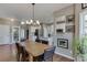 Bright kitchen with white cabinets and stainless steel appliances connected to the dining area for easy entertaining at 1673 Chadwick Ridge Dr, Lawrenceville, GA 30043
