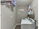 Clean laundry room features a modern washer and dryer with gray walls and wooden floors at 1673 Chadwick Ridge Dr, Lawrenceville, GA 30043