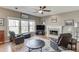 Inviting living room with a fireplace, large windows, and comfortable seating, creating an ideal space for relaxation at 1673 Chadwick Ridge Dr, Lawrenceville, GA 30043