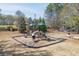 A well maintained playground featuring slides, swings, and benches surrounded by trees at 1673 Chadwick Ridge Dr, Lawrenceville, GA 30043