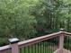 Deck overlooking the lush green yard with surrounding trees and foliage at 1673 Chadwick Ridge Dr, Lawrenceville, GA 30043