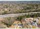 Aerial view showcasing houses with proximity to highway and commercial establishments at 6370 Boca Grande Blvd, Forest Park, GA 30297