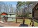 A wood deck overlooking the backyard, trees, and guest house beyond the lawn at 6370 Boca Grande Blvd, Forest Park, GA 30297