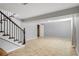 View of the basement with tile flooring, a finished staircase, and a small storage area at 6370 Boca Grande Blvd, Forest Park, GA 30297