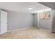 Neutral basement room with tiled floor, white walls, and a window at 6370 Boca Grande Blvd, Forest Park, GA 30297