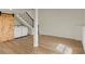 Large basement living space with hardwood floors and wood sliding barn door to laundry at 6370 Boca Grande Blvd, Forest Park, GA 30297