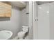 Simple bathroom featuring a stand up shower, toilet, sink, and wood cabinet at 6370 Boca Grande Blvd, Forest Park, GA 30297