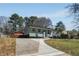 Charming home with a long driveway and a well-maintained lawn at 6370 Boca Grande Blvd, Forest Park, GA 30297