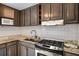 Close-up of a kitchen featuring granite countertops and stainless steel oven and gas cooktop at 6370 Boca Grande Blvd, Forest Park, GA 30297