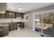 Cozy kitchen featuring stainless steel appliances, granite countertops, and sliding glass door to wooden deck at 6370 Boca Grande Blvd, Forest Park, GA 30297