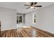Spacious living room with wood flooring, large window, and sliding door to a deck at 6370 Boca Grande Blvd, Forest Park, GA 30297