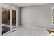 Living room featuring white-tiled floor, sliding glass door, and double-hung window at 6370 Boca Grande Blvd, Forest Park, GA 30297