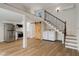 Multipurpose room with kitchen, laundry, and loft access, featuring wood-style flooring at 6370 Boca Grande Blvd, Forest Park, GA 30297