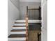Elegant staircase with wood railings and white risers, a warm inviting entryway at 6370 Boca Grande Blvd, Forest Park, GA 30297