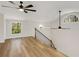 Lofted room with wood floors, ceiling fans, and a bright window at 6370 Boca Grande Blvd, Forest Park, GA 30297