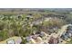 An aerial shot showcases the charming neighborhood, surrounded by mature trees and well-maintained homes at 6825 Concord Brook Ln, Cumming, GA 30028