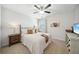 Comfortable bedroom featuring a decorative ceiling fan, plush carpet, and warm natural lighting at 6825 Concord Brook Ln, Cumming, GA 30028