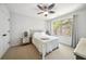 Cozy bedroom with a ceiling fan and a large window overlooking a wooded area at 6825 Concord Brook Ln, Cumming, GA 30028