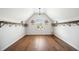 Bright bonus room with wood floors, open shelving, and vaulted ceilings provides lots of storage at 6825 Concord Brook Ln, Cumming, GA 30028
