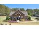 Charming community clubhouse with craftsman architecture, lush landscaping, and common green space at 6825 Concord Brook Ln, Cumming, GA 30028