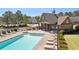 Community pool with comfortable lounge chairs and tables outside of neighborhood clubhouse at 6825 Concord Brook Ln, Cumming, GA 30028