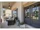 Inviting front porch with seating area, decorative wreaths on a charming front door, and flower filled pot at 6825 Concord Brook Ln, Cumming, GA 30028
