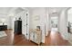 Bright hallway with hardwood floors and white trim leads to multiple bedrooms at 6825 Concord Brook Ln, Cumming, GA 30028
