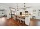 Open kitchen with a center island, stainless steel appliances, white cabinets, and hardwood floors at 6825 Concord Brook Ln, Cumming, GA 30028