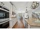 Gourmet kitchen features gas range, granite counters, stainless appliances, and seamless flow into the breakfast area at 6825 Concord Brook Ln, Cumming, GA 30028