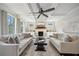 Inviting living room with coffered ceilings, fireplace, large windows, and neutral tones perfect for relaxing or entertaining at 6825 Concord Brook Ln, Cumming, GA 30028