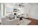 Bright living room featuring a fireplace, plush sofas, and large windows providing ample natural light for a comfortable space at 6825 Concord Brook Ln, Cumming, GA 30028