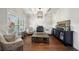 Living room featuring hardwood floors, coffered ceiling, stylish furniture, and plenty of natural light at 6825 Concord Brook Ln, Cumming, GA 30028
