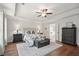 A spacious main bedroom with hardwood floors, tray ceiling, and sitting area at 6825 Concord Brook Ln, Cumming, GA 30028