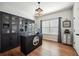 Well-appointed home office with built-in shelving, dark wood accents, and ample natural light, designed for productivity at 6825 Concord Brook Ln, Cumming, GA 30028