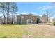 Expansive backyard featuring a well-maintained lawn, mature trees, and a spacious two-story house at 1561 Cooks Pond Dr, Powder Springs, GA 30127