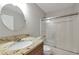Bright bathroom featuring granite countertop, a vessel sink, a shower and tub with sliding doors at 1561 Cooks Pond Dr, Powder Springs, GA 30127