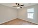 Bedroom featuring hardwood floors, ceiling fan, and a window that lets in natural light at 1561 Cooks Pond Dr, Powder Springs, GA 30127