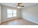This bedroom includes hardwood floors, a ceiling fan with light and a window for great natural light at 1561 Cooks Pond Dr, Powder Springs, GA 30127