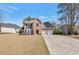 Charming brick home featuring a well-manicured lawn and a two-car garage at 1561 Cooks Pond Dr, Powder Springs, GA 30127