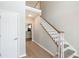 Inviting foyer showcasing hardwood floors and staircase with decorative white banister at 1561 Cooks Pond Dr, Powder Springs, GA 30127