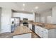 Spacious kitchen with stainless steel appliances, granite countertops, white cabinets, and tile flooring at 1561 Cooks Pond Dr, Powder Springs, GA 30127