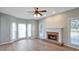 Inviting living room with hardwood floors, a cozy fireplace, and abundant natural light at 1561 Cooks Pond Dr, Powder Springs, GA 30127