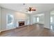 Bright living room with fireplace, ceiling fan, and seamless flow to the dining area at 1561 Cooks Pond Dr, Powder Springs, GA 30127