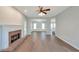 Open living room boasts a traditional fireplace, hardwood floors, and ample natural light at 1561 Cooks Pond Dr, Powder Springs, GA 30127