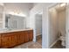Bathroom featuring double sink vanity with granite countertop, tile floors, and access to water closet at 1561 Cooks Pond Dr, Powder Springs, GA 30127