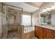 Beautiful bathroom with a walk-in shower, soaking tub, granite countertop vanity, and tiled walls at 1561 Cooks Pond Dr, Powder Springs, GA 30127